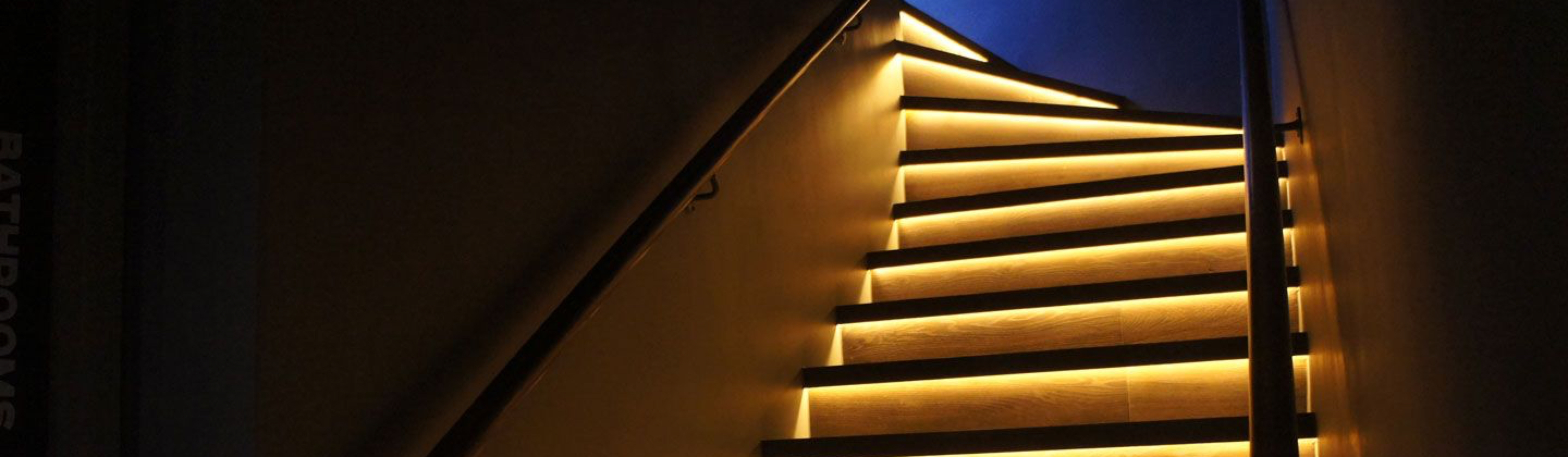 Staircase warm LED lighting strips.